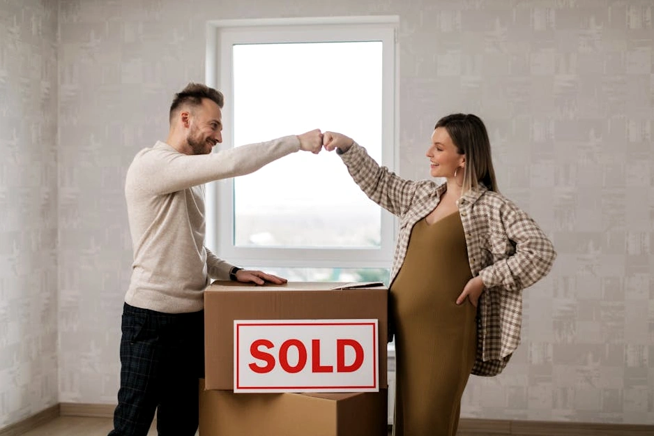 A relaxed couple looking at a tablet in a sunlit living room